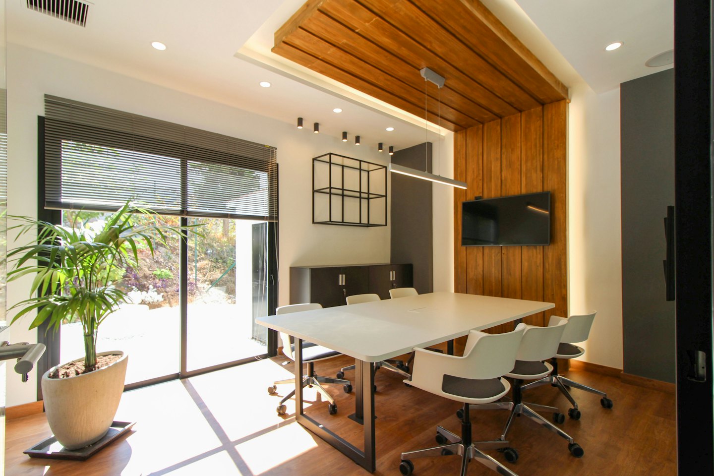 Modern corporate meeting room with a large table and chairs.
